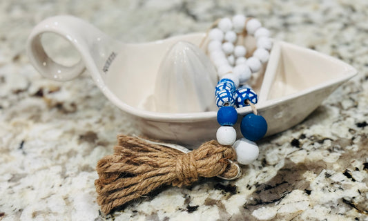 Rae Dunn ceramic SQUEEZE juicer and handmade beaded blue line decor